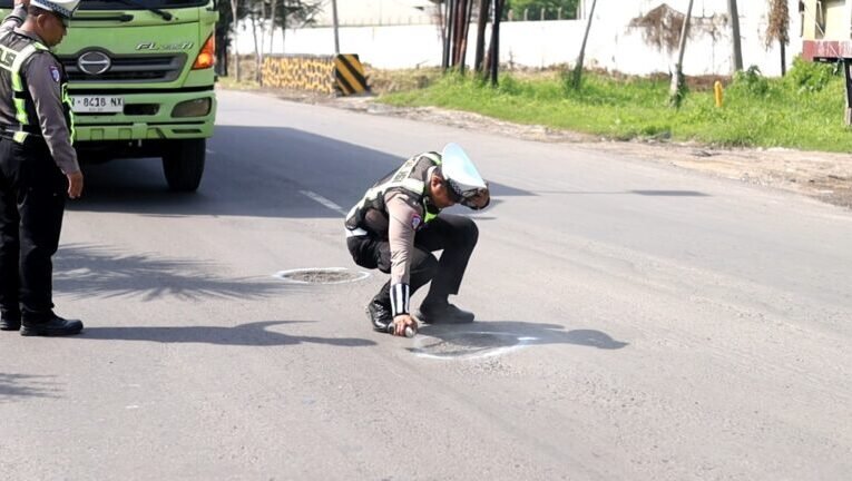Jelang Nataru, Polres Gresik Tandai Jalan Berlubang di Raya Deandles Demi Keselamatan Pengendara